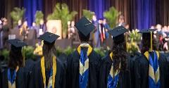 Group of graduates facing the stage